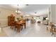 Open-concept living area with tile floors, dining space, and a view of the outdoor pool at 3319 Barrington Ct, The Villages, FL 32162