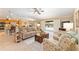 Open-concept living room showcasing access to kitchen and outdoor pool area at 3319 Barrington Ct, The Villages, FL 32162