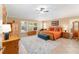 A bright main bedroom boasts tile flooring, plantation shutters, and classic wooden furniture at 3319 Barrington Ct, The Villages, FL 32162