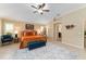 A bright main bedroom boasts tile flooring, plantation shutters, and classic wooden furniture at 3319 Barrington Ct, The Villages, FL 32162