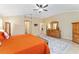 A bright main bedroom boasts tile flooring, plantation shutters, and classic wooden furniture at 3319 Barrington Ct, The Villages, FL 32162