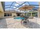 Inviting pool area featuring a spa, screened enclosure, and outdoor seating, perfect for relaxing and entertaining at 3319 Barrington Ct, The Villages, FL 32162