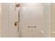 Modern tiled shower featuring a bronze shower head and grab bar, with a convenient built-in seat at 3319 Barrington Ct, The Villages, FL 32162