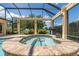 Screened-in spa with a spillover feature, surrounded by lush landscaping and ample seating at 3319 Barrington Ct, The Villages, FL 32162