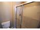 Bathroom featuring shower with glass door and white toilet at 3329 White Blossom Ln, Clermont, FL 34711