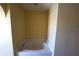 Cozy soaking tub featuring tile surround, neutral walls, and a sleek faucet at 3329 White Blossom Ln, Clermont, FL 34711