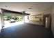 Open garage featuring a gray painted floor, an open door facing the street, and a workbench on the right at 3329 White Blossom Ln, Clermont, FL 34711