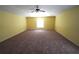 Large main bedroom with carpet flooring, a ceiling fan, and a window at 3329 White Blossom Ln, Clermont, FL 34711