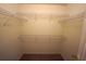 Walk-in closet featuring built-in shelving units for organization at 3329 White Blossom Ln, Clermont, FL 34711