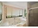 Bright bathroom with a large soaking tub and glass-enclosed shower at 34 Gordon Ct, Leesburg, FL 34788