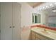 Cozy bathroom featuring a vanity, mirror, and storage cabinet at 34 Gordon Ct, Leesburg, FL 34788