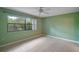 Large bedroom featuring tiled floors and a large window with nature view at 34 Gordon Ct, Leesburg, FL 34788