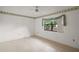 Bedroom featuring carpeted floors and large window at 34 Gordon Ct, Leesburg, FL 34788