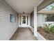 Covered entryway with front door framed by sidelights, leading into the home at 34 Gordon Ct, Leesburg, FL 34788