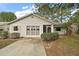 Charming single-story home with a well-manicured lawn and a screened entry at 34 Gordon Ct, Leesburg, FL 34788