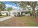 Cozy single-Gathering house with well-kept lawn and mature shade trees at 34 Gordon Ct, Leesburg, FL 34788