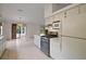 Open kitchen showcasing stainless steel appliances and easy access to outdoor patio at 34 Gordon Ct, Leesburg, FL 34788