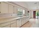 Bright kitchen featuring a large sink, under cabinet lighting, and tiled flooring at 34 Gordon Ct, Leesburg, FL 34788