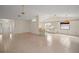 Spacious living area with tile flooring, leading to the kitchen and front entry at 34 Gordon Ct, Leesburg, FL 34788