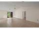 Bright living room features tile flooring and a sliding glass door to the outdoors at 34 Gordon Ct, Leesburg, FL 34788
