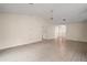 Open concept living area with tile flooring and access to various rooms at 34 Gordon Ct, Leesburg, FL 34788