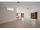 Bright living room with tile flooring and a view of the screened patio at 34 Gordon Ct, Leesburg, FL 34788