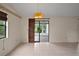Open living room with tiled floors and view of enclosed sun room at 34 Gordon Ct, Leesburg, FL 34788