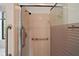 Close up of a tiled stand-up shower with assist bar at 34 Gordon Ct, Leesburg, FL 34788