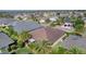 Drone shot displays a residential property with backyard, palm trees, and neighborhood houses at 3433 Nestlebranch Ave, The Villages, FL 32163