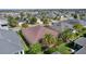 An elevated perspective of a well-maintained residential property within a community with lush green lawns and mature trees at 3433 Nestlebranch Ave, The Villages, FL 32163