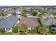 Overhead angle highlighting a cozy home with a landscaped yard, palm trees and a clear view of surrounding neighborhood at 3433 Nestlebranch Ave, The Villages, FL 32163