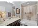 Bathroom features a vanity with a sink, framed mirror, and shower over tub at 3433 Nestlebranch Ave, The Villages, FL 32163