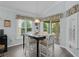 Cozy dining area with lots of windows, light, and a glass table at 3433 Nestlebranch Ave, The Villages, FL 32163