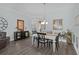 Formal dining area with modern decor, elegant chandelier, wainscotting and seamless access to other rooms via an open doorway at 3433 Nestlebranch Ave, The Villages, FL 32163