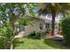 Backyard with a cozy patio, hot tub, and well-maintained lawn at 3433 Nestlebranch Ave, The Villages, FL 32163