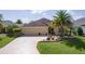 Charming home with a well-kept lawn, landscaped garden, and convenient two-car garage at 3433 Nestlebranch Ave, The Villages, FL 32163