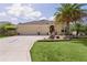 Charming single-story home with manicured lawn and mature palm trees at 3433 Nestlebranch Ave, The Villages, FL 32163