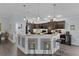 Open kitchen featuring stainless steel appliances, pendant lights, and granite counters at 3433 Nestlebranch Ave, The Villages, FL 32163