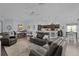 Open concept living room that blends seamlessly into the dining and kitchen area, complete with hardwood floors and neutral decor at 3433 Nestlebranch Ave, The Villages, FL 32163