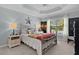 Cozy main bedroom featuring a tray ceiling and natural light at 3433 Nestlebranch Ave, The Villages, FL 32163