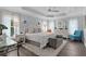 Spacious main bedroom features a tray ceiling, hardwood floors, a ceiling fan, and lots of natural light at 3433 Nestlebranch Ave, The Villages, FL 32163