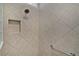 New shower with tiled walls, grab bar, and built-in niche at 3433 Nestlebranch Ave, The Villages, FL 32163