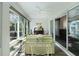 Inviting sunroom with tile floors, ceiling fan and windows overlooking the backyard at 3433 Nestlebranch Ave, The Villages, FL 32163