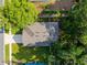 Aerial view of the home featuring a well-maintained roof, driveway, and mature trees at 35107 Sweet Leaf Ln, Leesburg, FL 34788