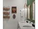 Bathroom showcasing a double vanity with stylish fixtures, mirrors, and decorative wall accents at 35107 Sweet Leaf Ln, Leesburg, FL 34788