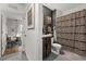Well-lit bathroom featuring a stylish shower curtain and modern fixtures at 35107 Sweet Leaf Ln, Leesburg, FL 34788