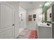 Bathroom featuring a walk-in shower, double vanity, and decorative shelving at 35107 Sweet Leaf Ln, Leesburg, FL 34788