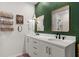 Stylish bathroom featuring double sinks, modern fixtures, and a decorative accent wall at 35107 Sweet Leaf Ln, Leesburg, FL 34788