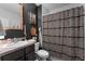 Stylish bathroom featuring black walls, patterned shower curtain, and gold-framed mirror at 35107 Sweet Leaf Ln, Leesburg, FL 34788