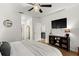 Open bedroom floor plan featuring an entertainment center, TV, and access to ensuite bathroom at 35107 Sweet Leaf Ln, Leesburg, FL 34788